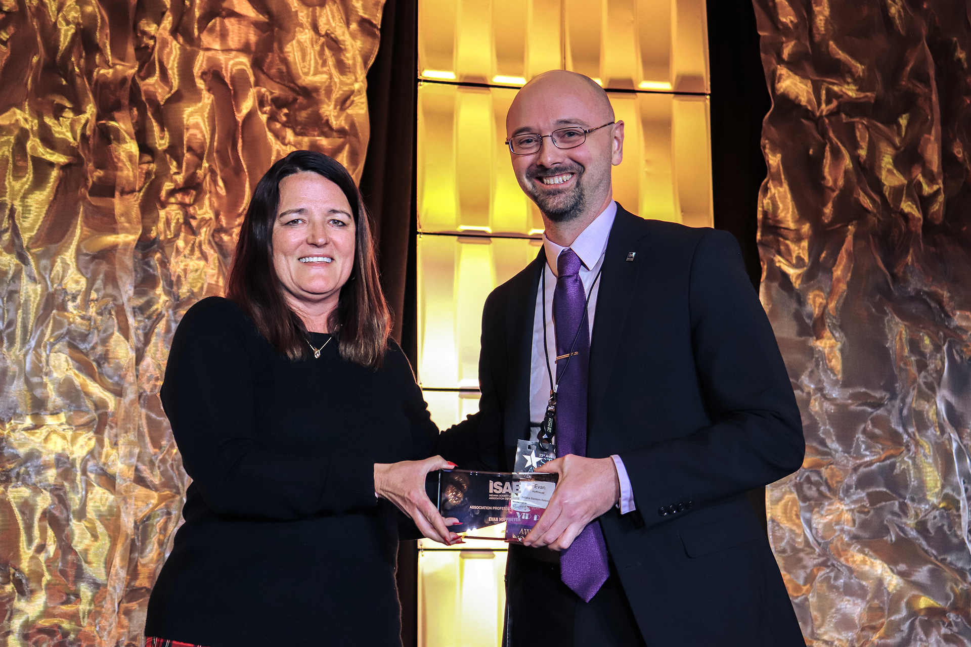 photo showing Amber Van Til posing with the 2023 Association Executive of the Year award