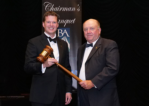 Lucas White receiving Chairman's gavel from Andrew Briggs